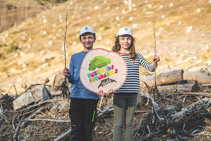 Linda und Lennox Beese präsentieren Schößlinge, die im United Kids Foundations Wald gepflanzt werden. Linda und Lennox Beese präsentieren Schößlinge, die im United Kids Foundations Wald gepflanzt werden.