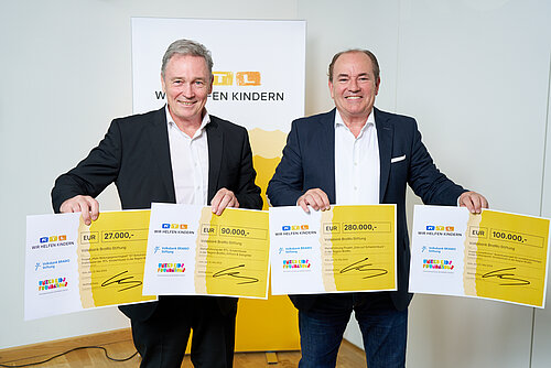 Thomas Fast (l.), Vorstandsvorsitzender der Volksbank BRAWO Stiftung, nahm die symbolischen Spendenschecks von Wolfram Kons, Vorstandsmitglied der "Stiftung RTL - Wir helfen Kindern e. V.", i. H. v. 470.000 Euro für Projekte in der BRAWO-Region entgegen.