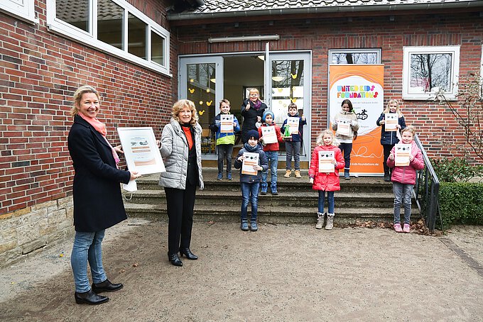 Schulleiterin Ulrike Svetlik (l.) nimmt die Siegerurkunde für den Direktionssieg in Wolfsburg bei step-BraWo von Claudia Kayser, Botschafterin von United Kids Foundations, entgegen. Foto: Volksbank BraWo / Cagla Canidar / KURT Media